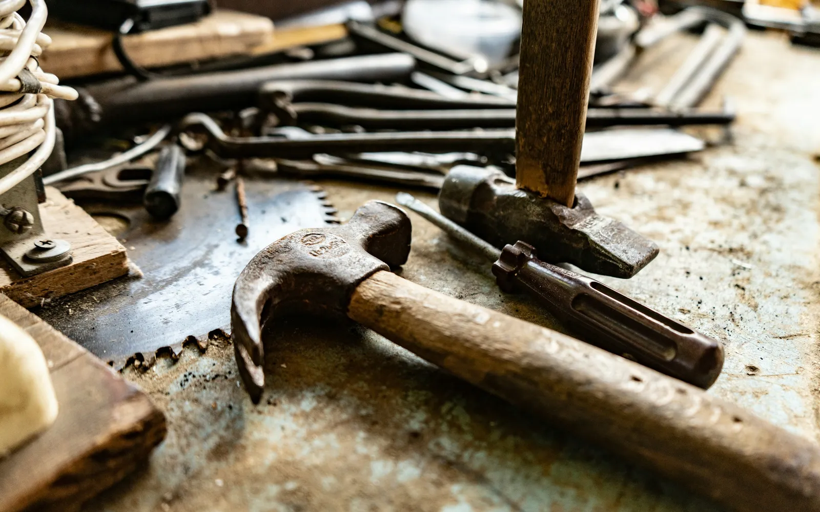 A tradesperson’s hand tools laid out on a bench