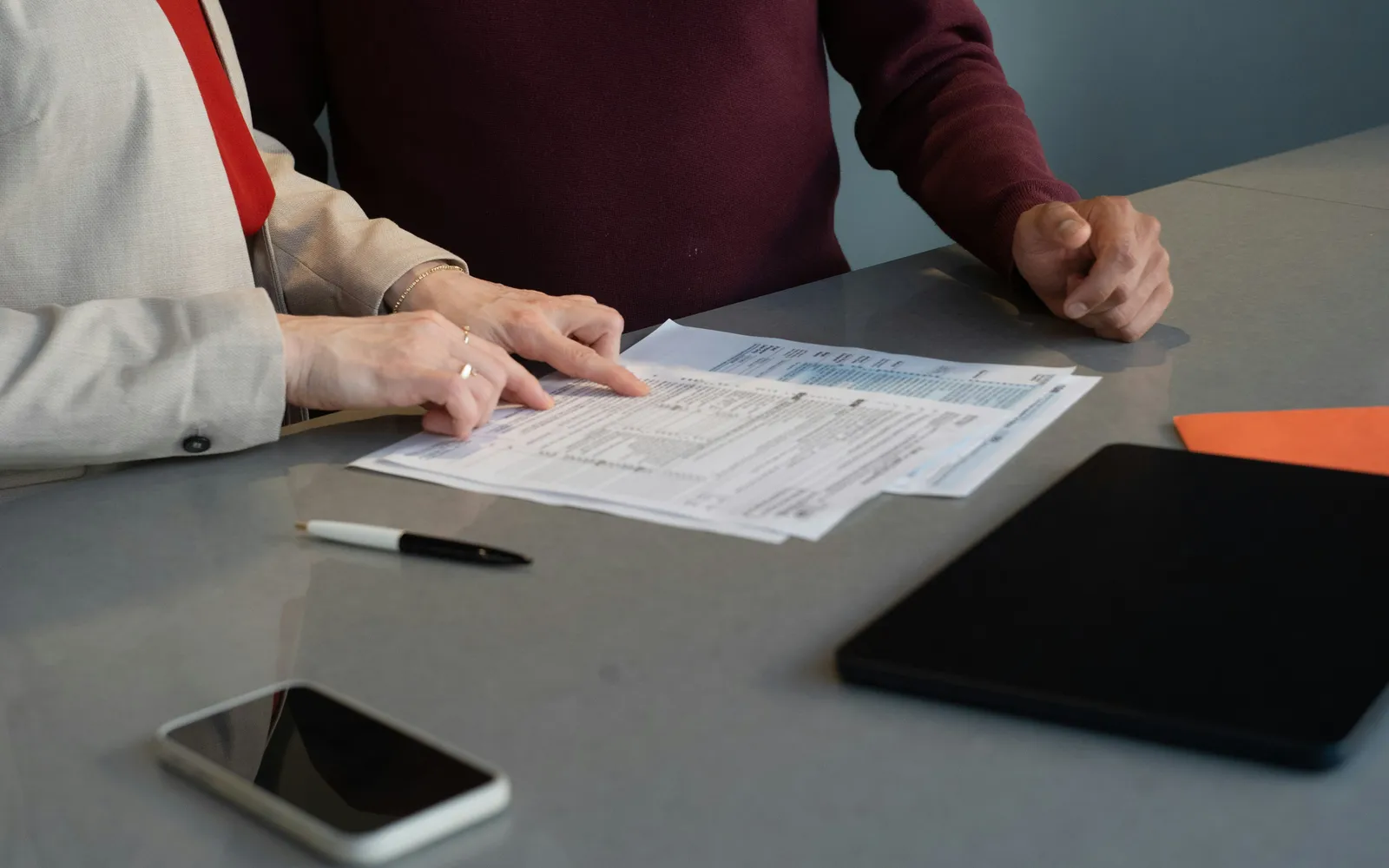 Documents being reviewed across a desk