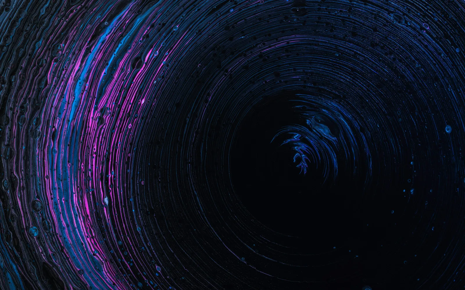 A dark blue vortex of light trails
